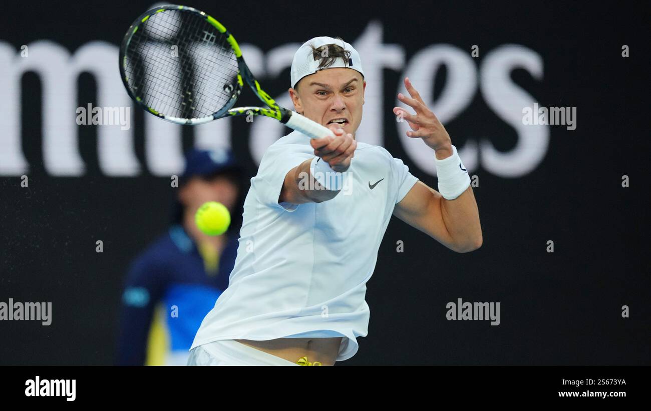 Holger Rune of Denmark returns a shot against Matteo Berrettini of