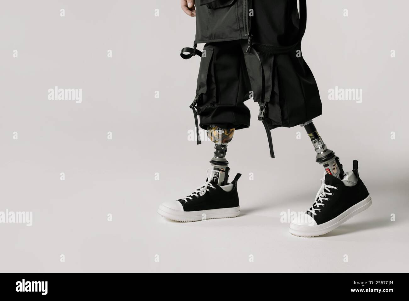 A Man with a prosthetic leg Sitting on Stool Stock Photo