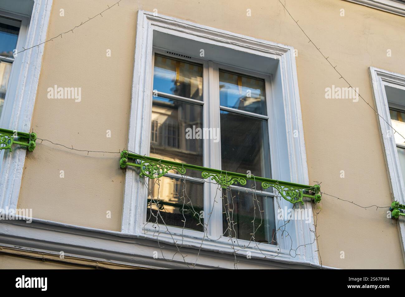 Charming window with decorative green railing and twinkling lights at ...