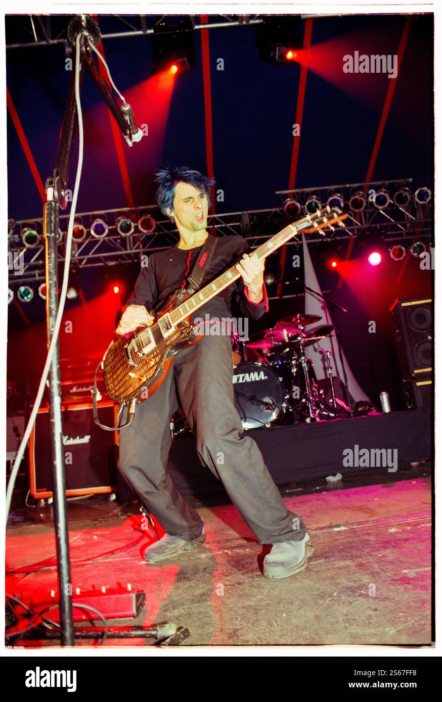 MUSE, YOUNG, READING FESTIVAL, 2000: An early career picture of singer songwriter Matt Bellamy from the English rock band Muse band playing live on the Melody Maker Stage with their debut album 'Showbiz' at Reading Festival, Reading, UK on 25 August 2000. Photo: Rob Watkins. INFO: Muse is a British rock band formed in 1994, known for their electrifying performances and genre-blending sound, fusing alternative rock, electronic, and symphonic elements. With hits like 'Uprising' and Black Holes and Revelations, they became global rock icons. Stock Photo