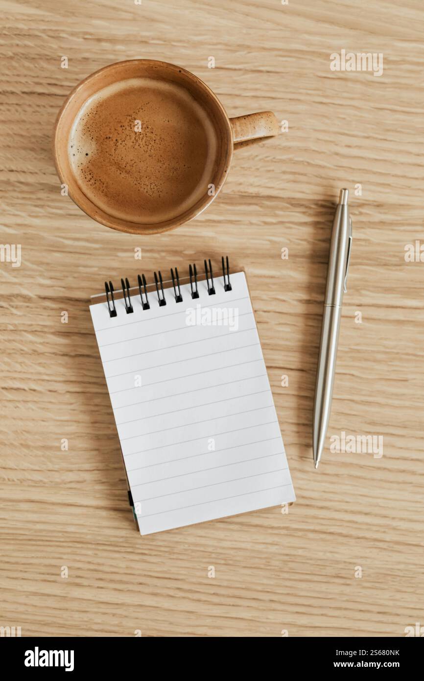 Cup of espresso and notebook with pen Stock Photo