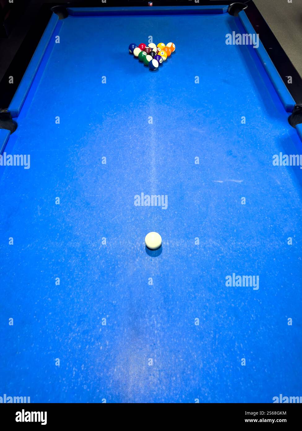 Pool table set up for a game with balls arranged in triangle formation Stock Photo