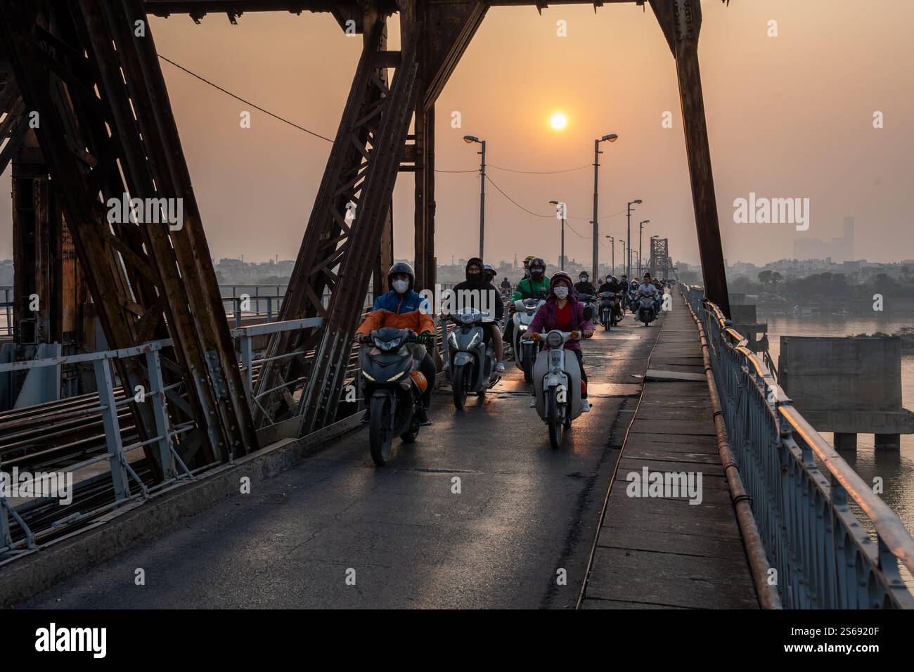Vietnamese Motorbike Driver at the Long Bien Bridge in Hanoi City Vietnam Southeast Asia Stock Photo