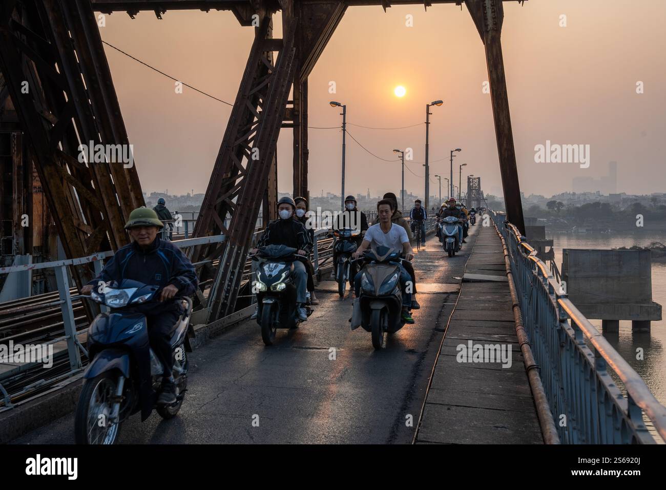 Vietnamese Motorbike Driver at the Long Bien Bridge in Hanoi City Vietnam Southeast Asia Stock Photo