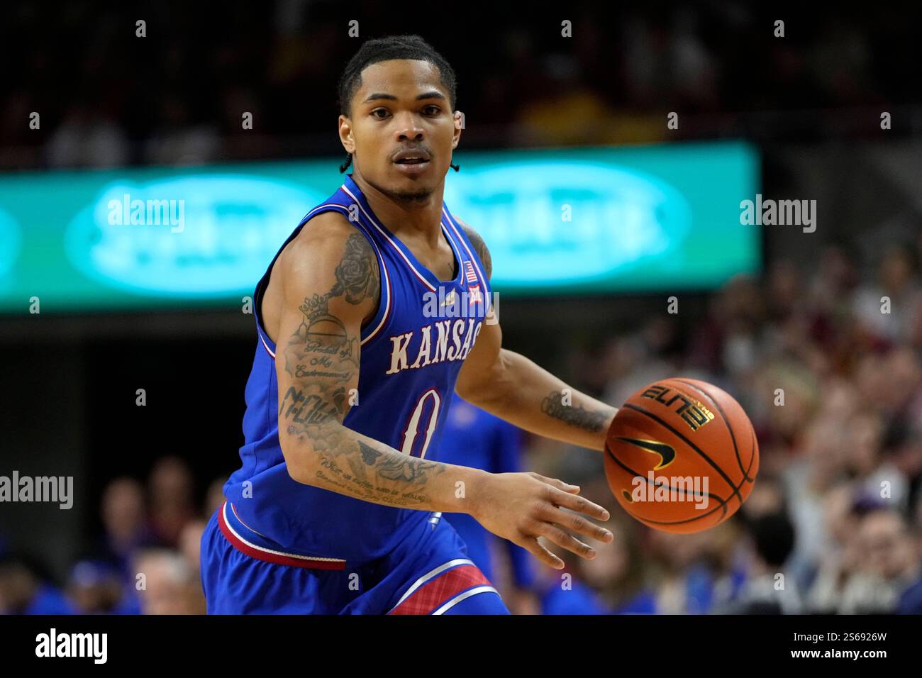Kansas guard Shakeel Moore (0) drives up court during the first half of