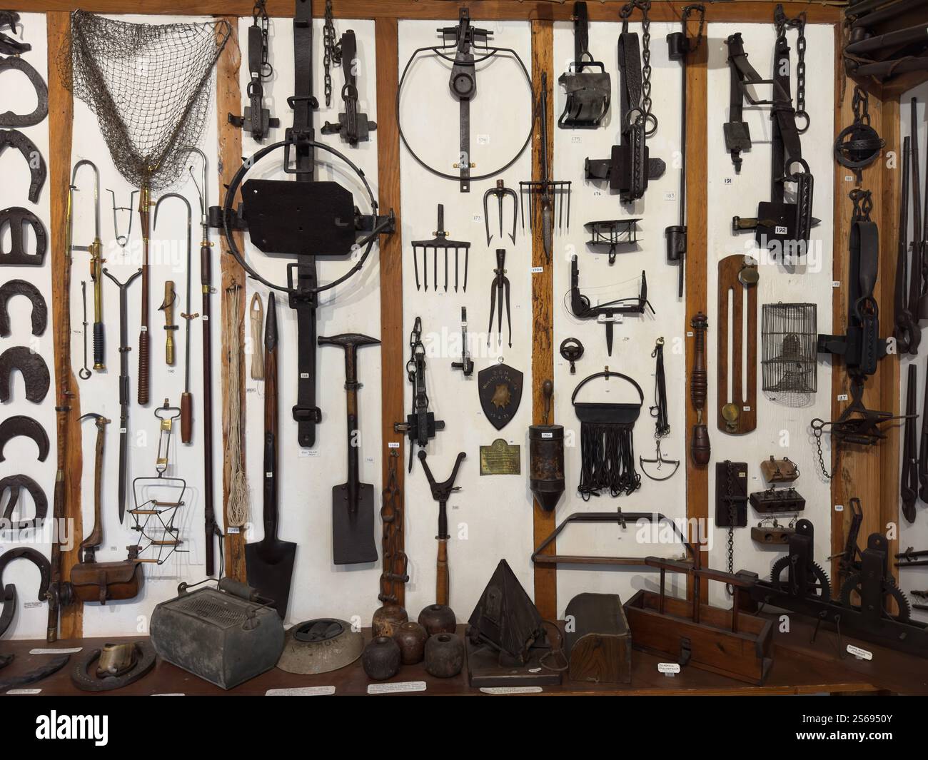 A wall of traditional farming tools at the Waterperry Gardens Farming Museum - Smartphone Captured Stock Image