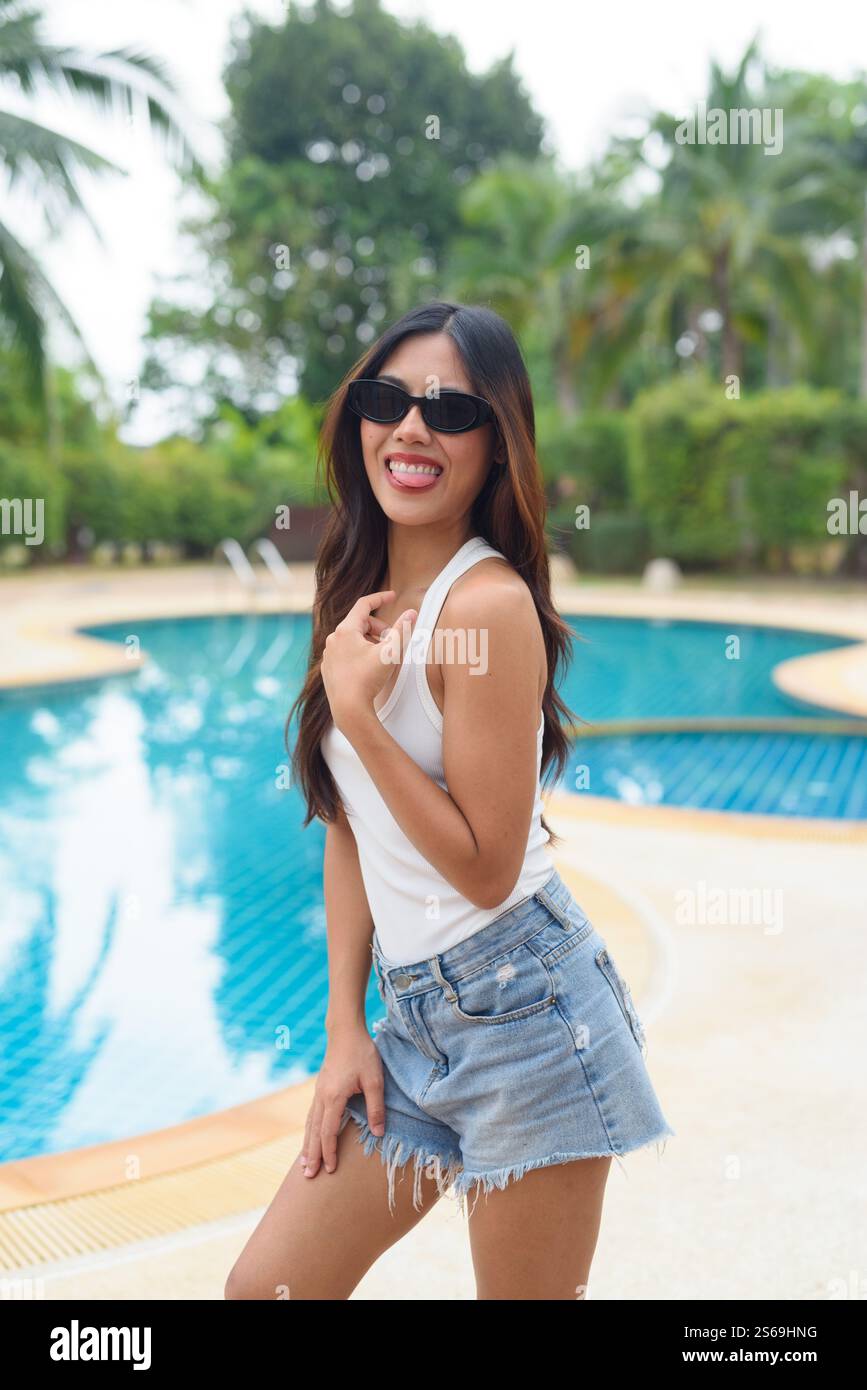 Young Asian woman swimming pool portrait Stock Photo - Alamy