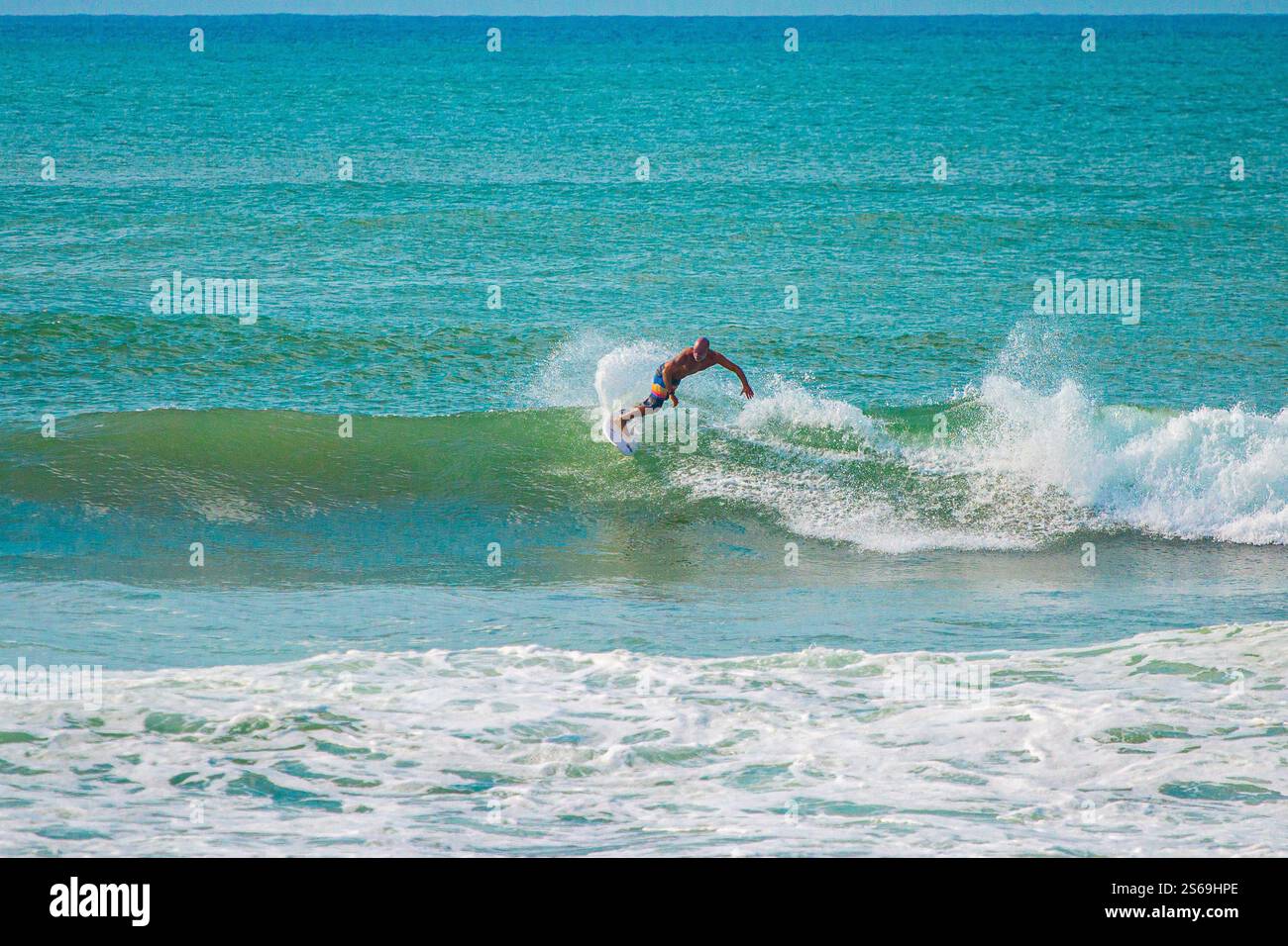 A mesmerizing moment of oceanic splendor: a skilled surfer carves ...