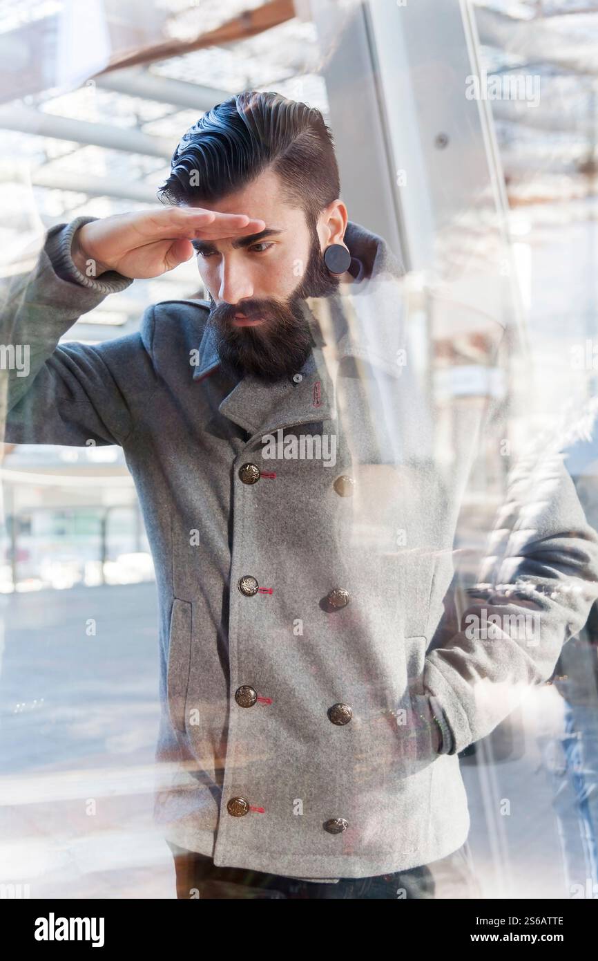 businessman looking through window Stock Photo