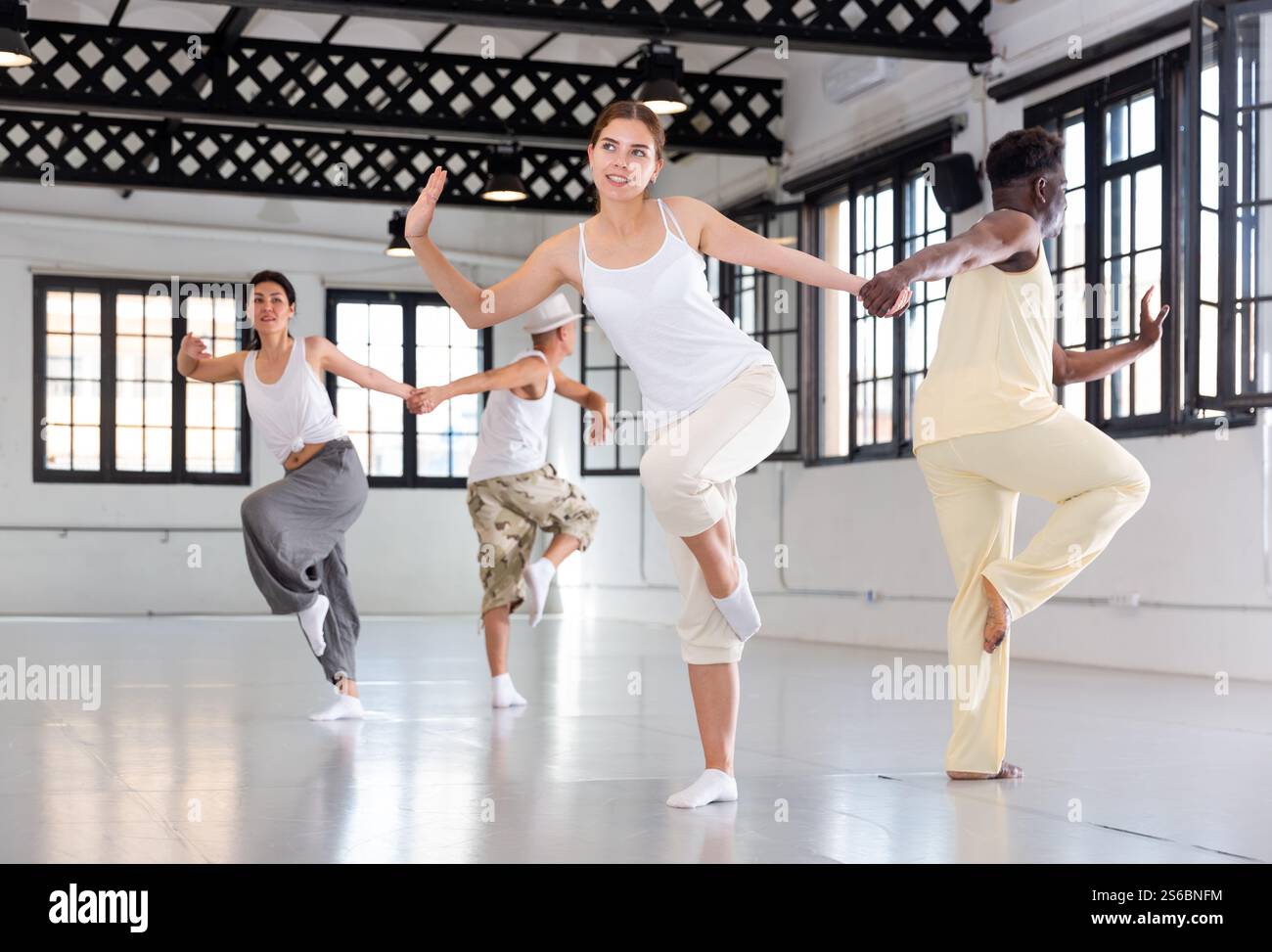 Four dancers exercising swing movements Stock Photo