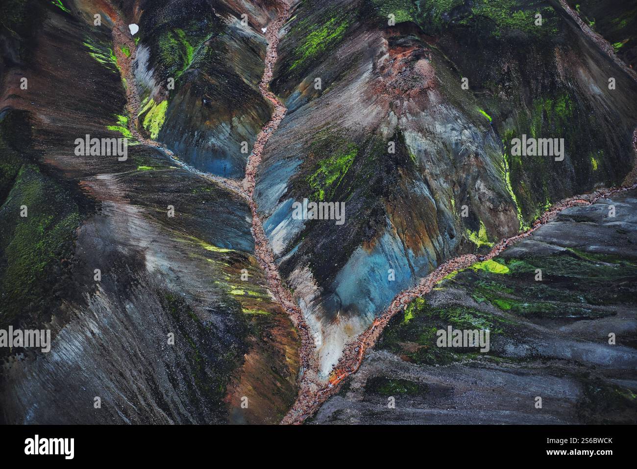Aerial view of a vibrant geothermal area in Iceland, showcasing colorful mineral deposits, steaming vents, and a surreal volcanic landscape Stock Photo