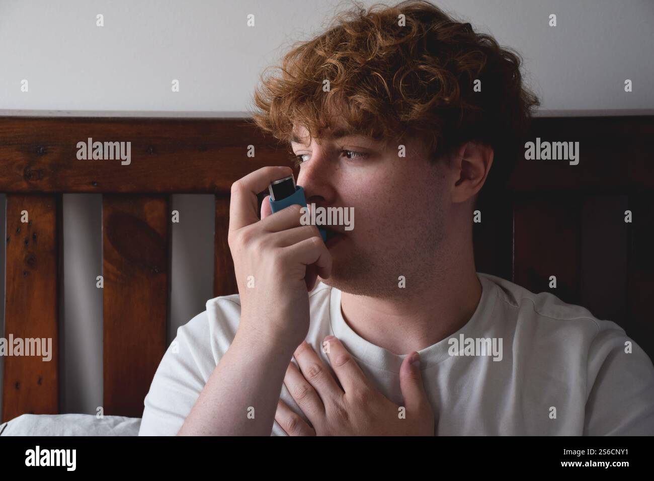 Young man using inhailer for asthma attack Stock Photo