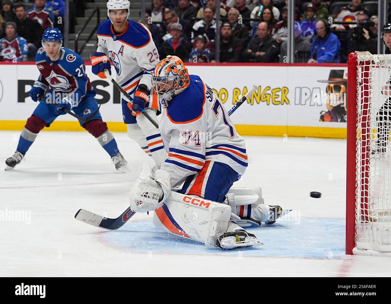 Edmonton Oilers goaltender Stuart Skinner, front, allows a shot by ...