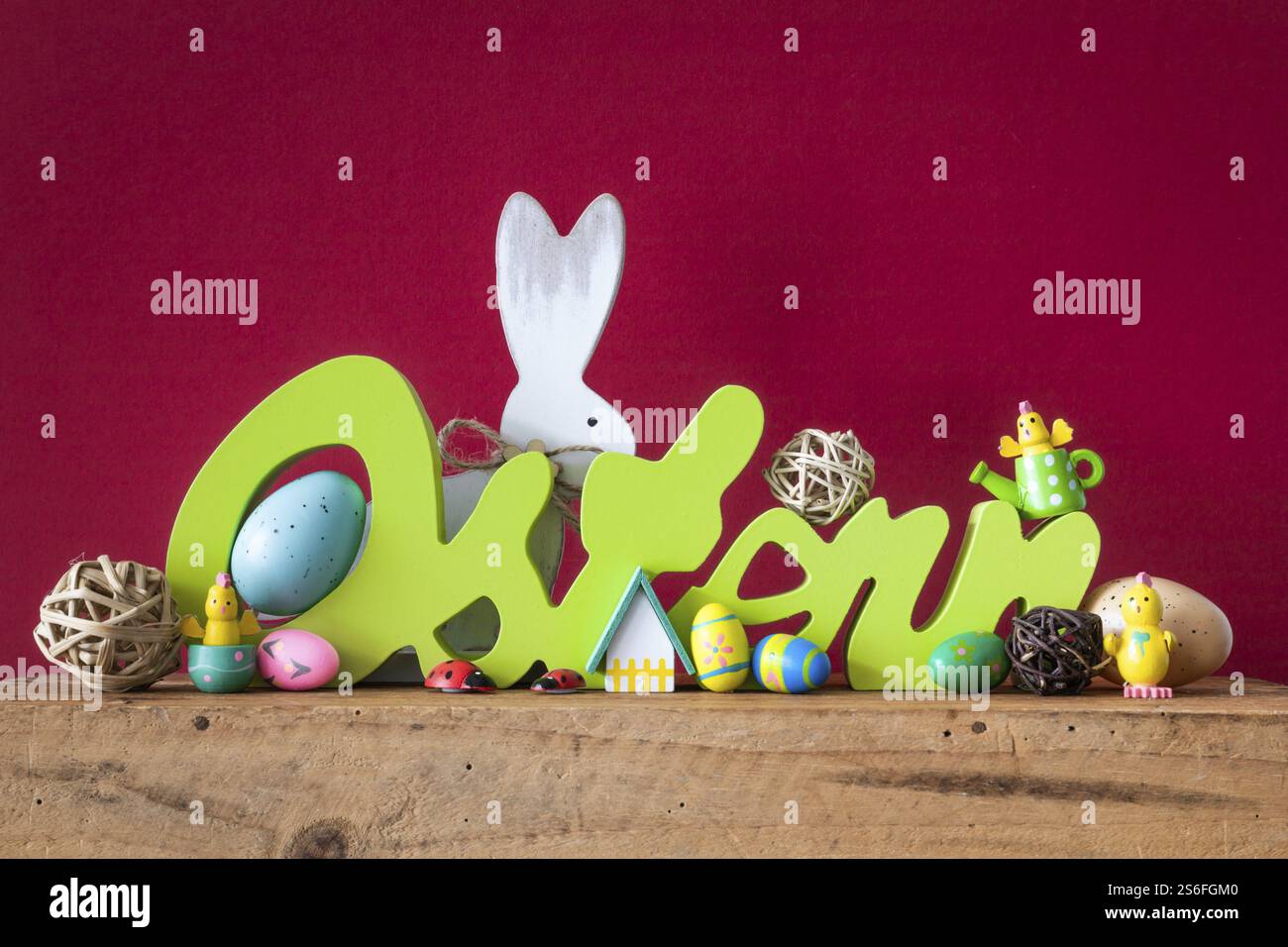 The word Easter in german language with easter bunny eggs and chicks Stock Photo