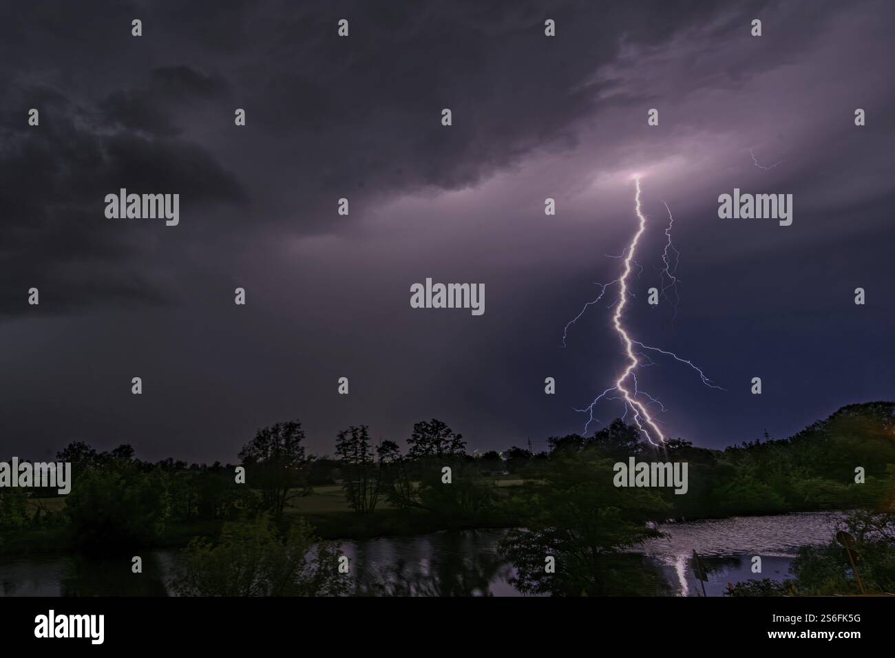 Illuminating lightning strikes the night sky over a landscape, Bogen ...
