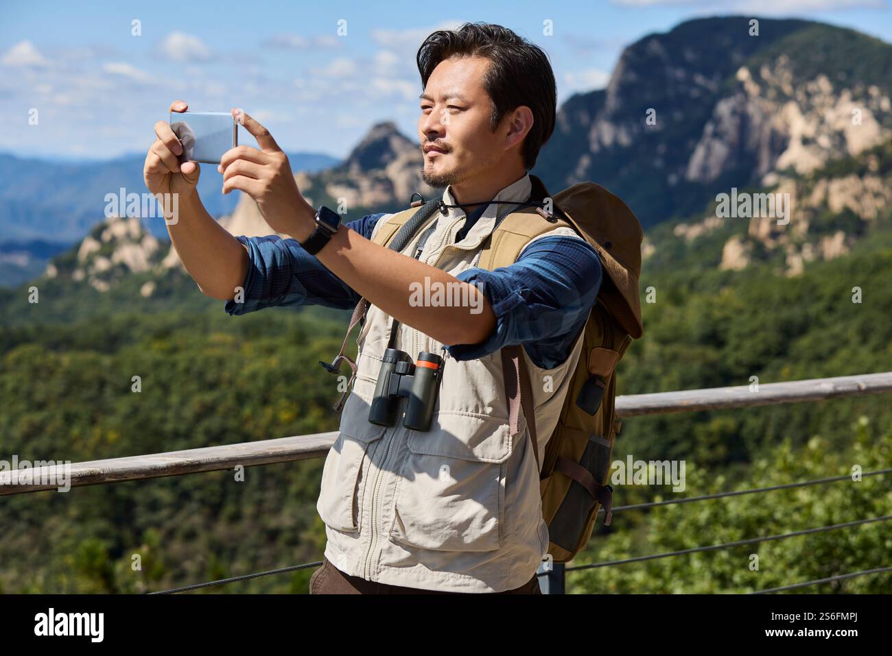 Happy man hiking in the mountains Stock Photo - Alamy