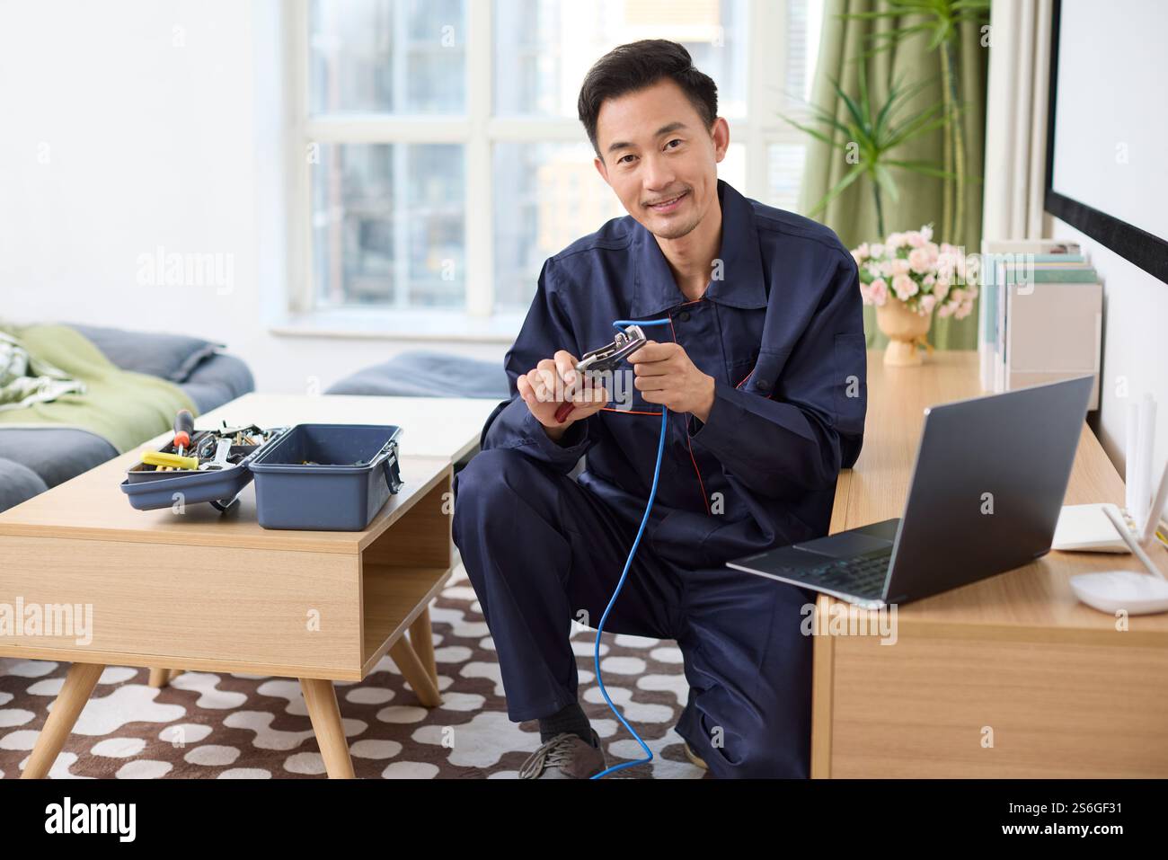 IT technician fixing internet cable Stock Photo