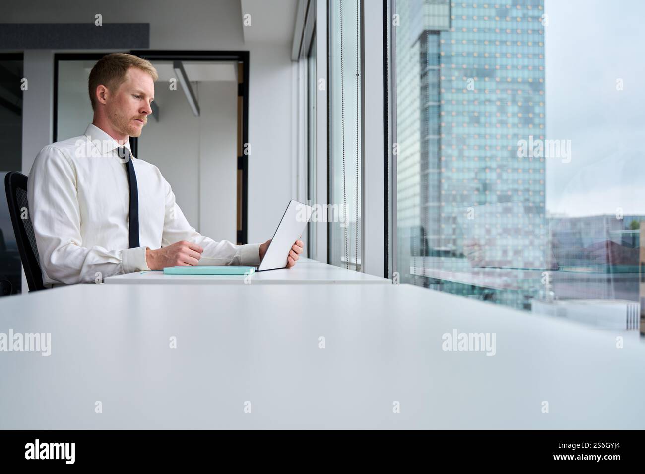 Busy professional business man manager using laptop working at table. Stock Photo