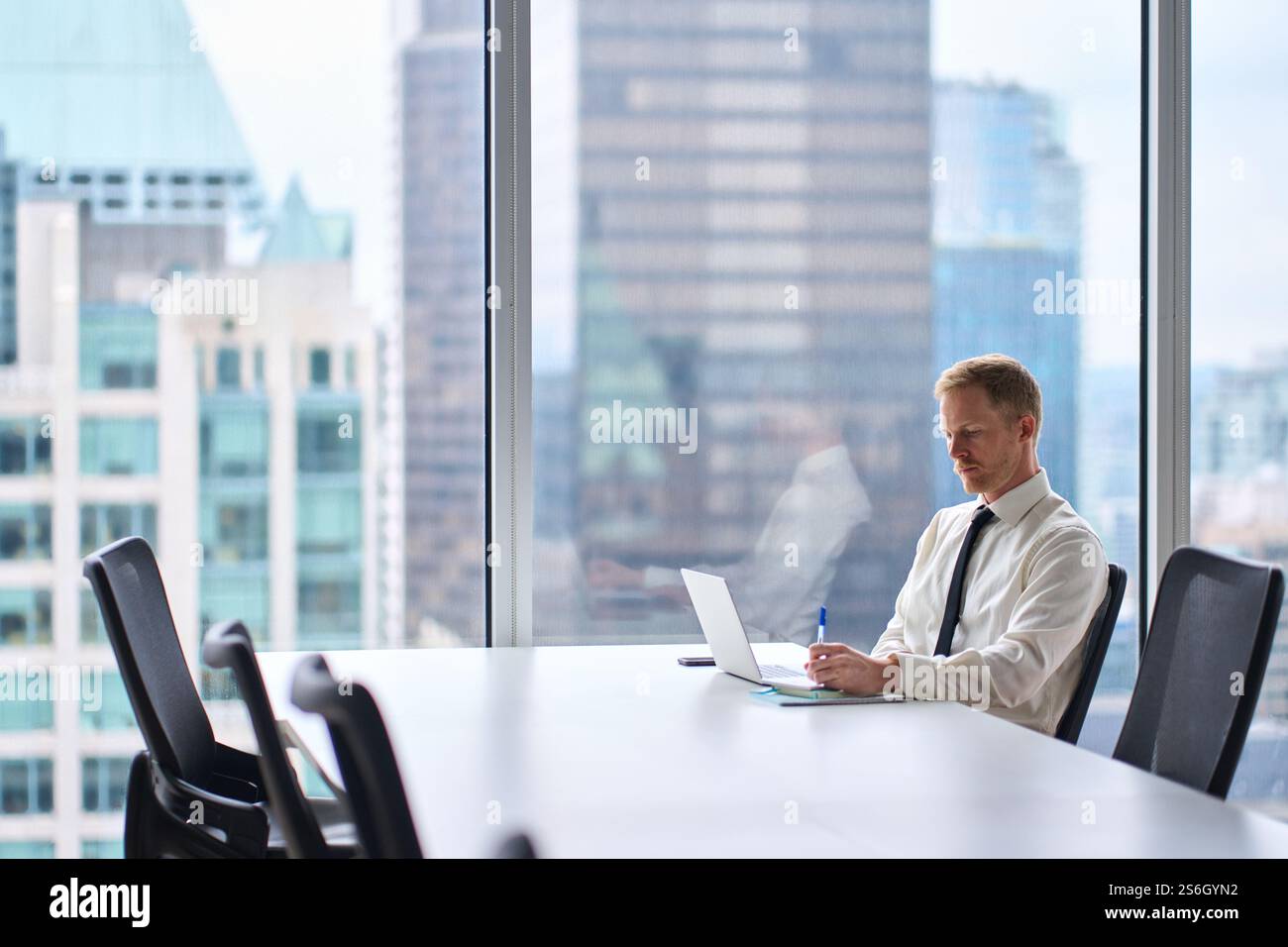Busy businessman financial analyst or manager using computer at work. Stock Photo