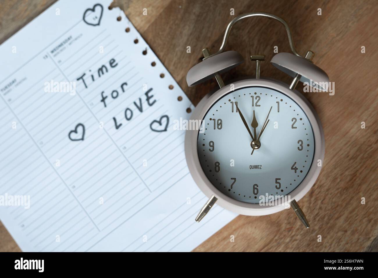 Clock with note 'Time for love' Stock Photo