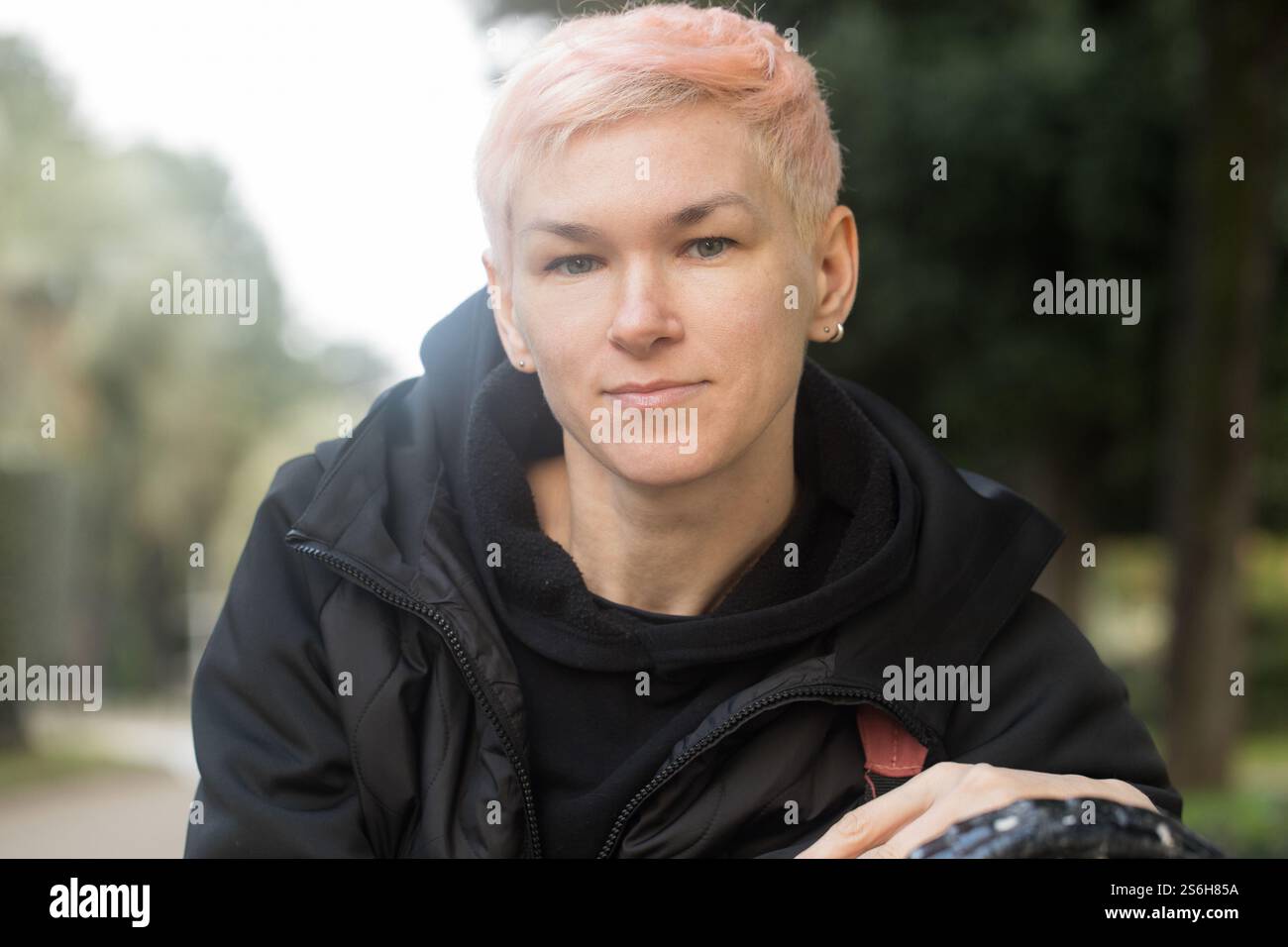 Beautiful mature woman sitting on a park bench Stock Photo - Alamy