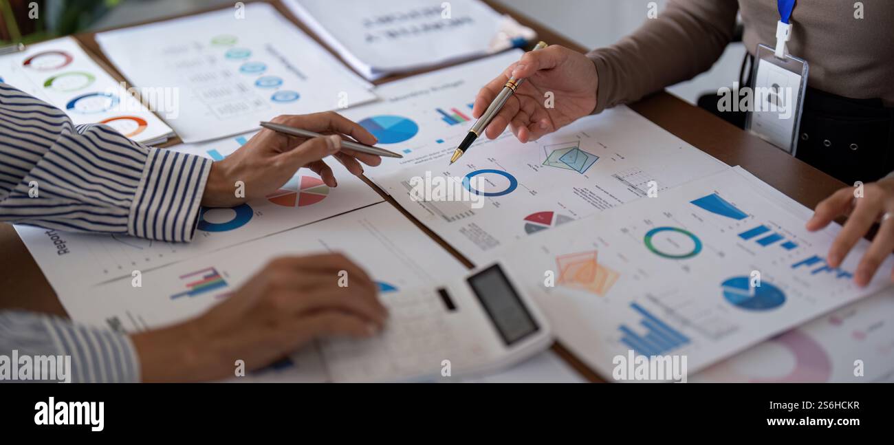 Business team collaborating on financial analysis with charts and ...