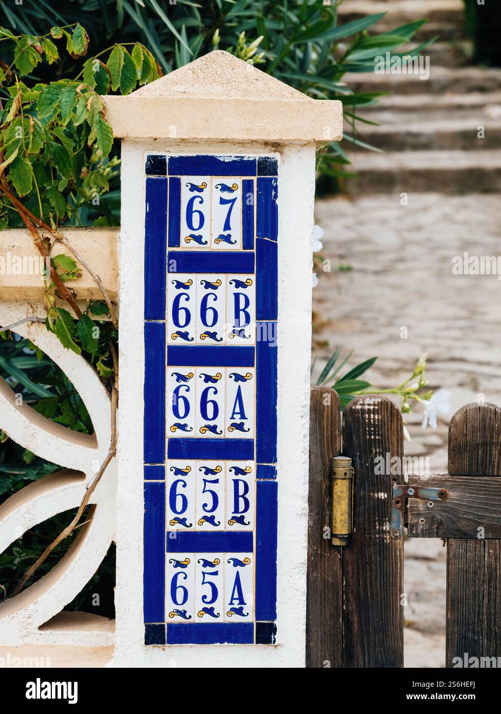 White Gate Numbers A white pillar featuring blue and white ceramic tiles with house ...