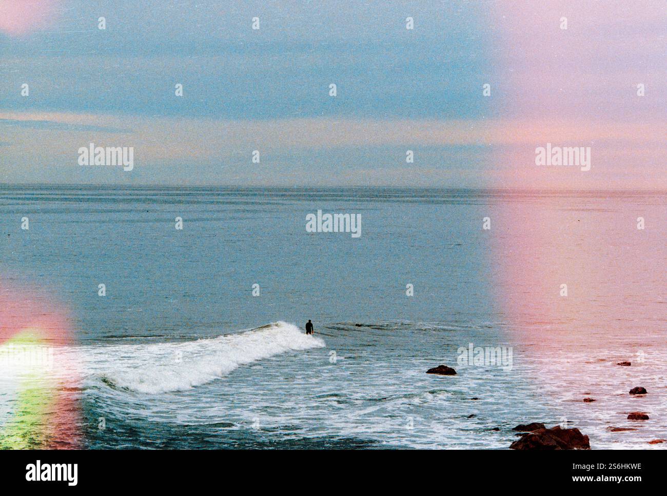 Waves Crashing Against the Shore with Subtle Light Leaks Stock Photo