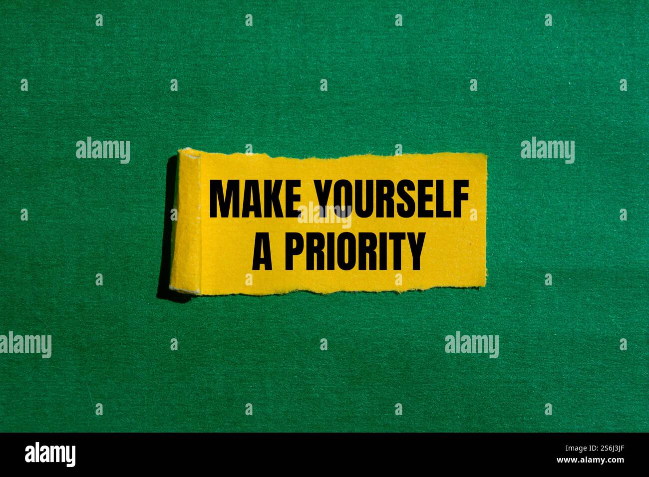 Make yourself a priority message written on ripped torn yellow paper ...