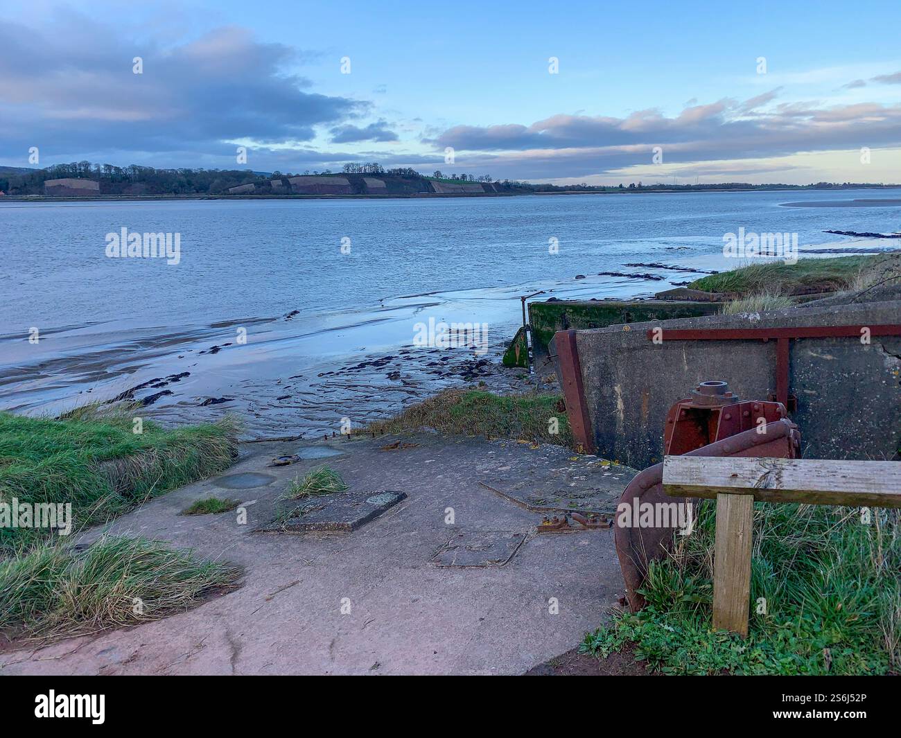Obsolete small boats and barges were stranded on the banks of the tidal River Severn in Gloucestershire, UK to protect the river banks from erosion. Now they form an atmospheric local attraction to sightseers. - Smartphone Captured Stock Image