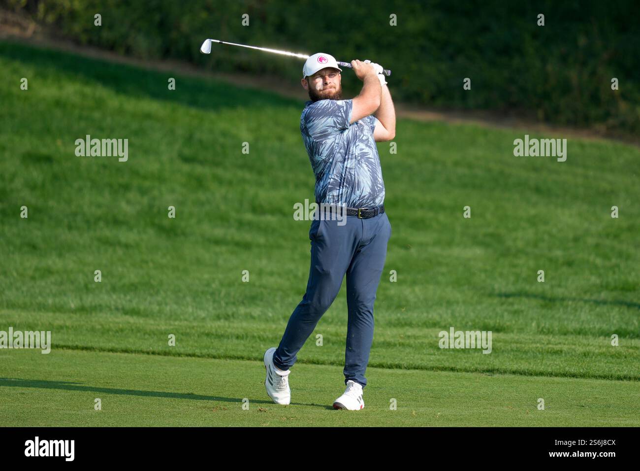 Tyrell Hatton of England plays his second shot on the 9th hole during