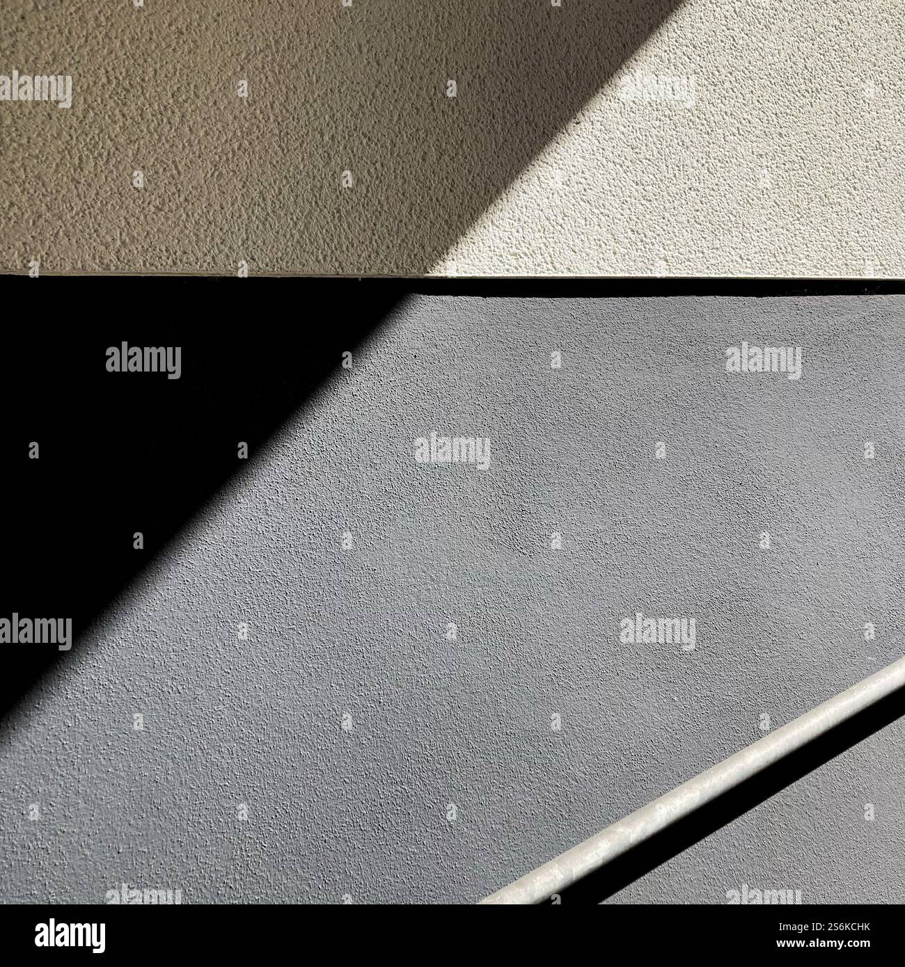 A minimalist, geometric design featuring shadows and diagonal lines on textured surfaces, evoking balance and simplicity. - Smartphone Captured Stock Image