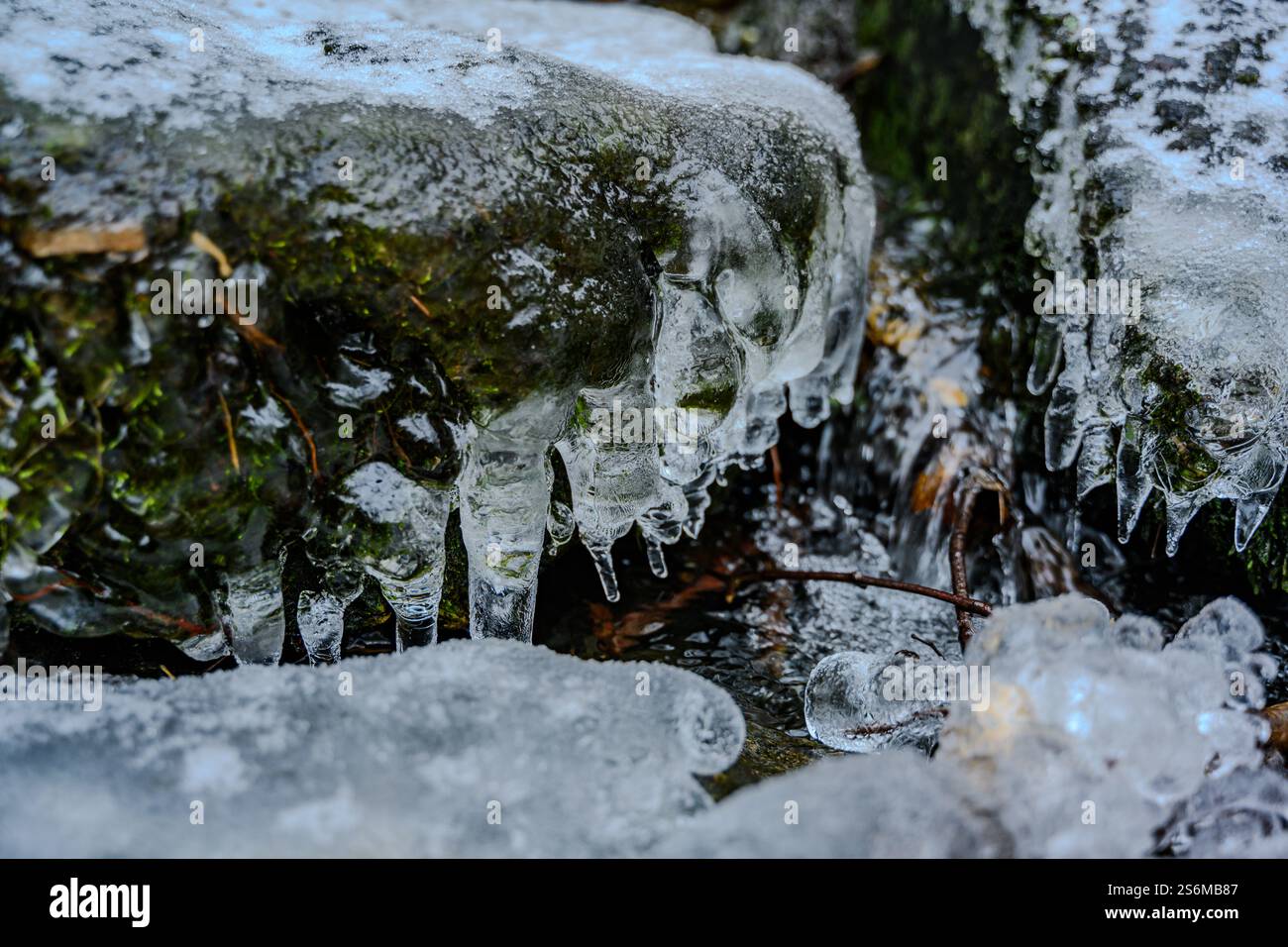 Tiny icicles covering rock at a small cascade Stock Photo
