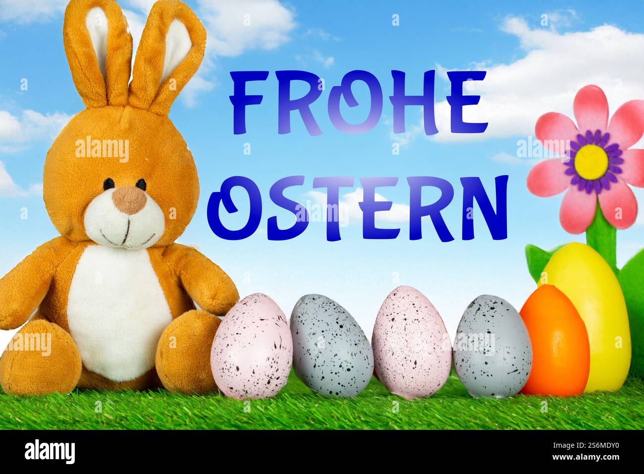 Easter greetings: Easter bunny with colourful Easter eggs with text FROHE OSTERN (Composing) Stock Photo