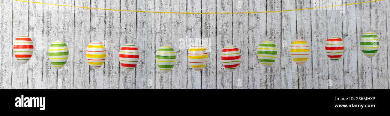 Colorful Easter eggs on a string in a row Stock Photo