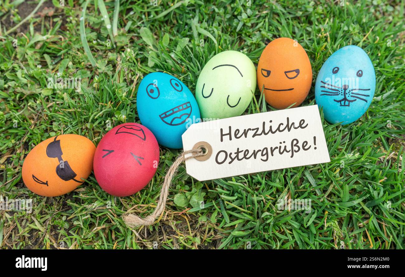 Easter eggs and greeting card with German text: Warm Easter greetings Stock Photo