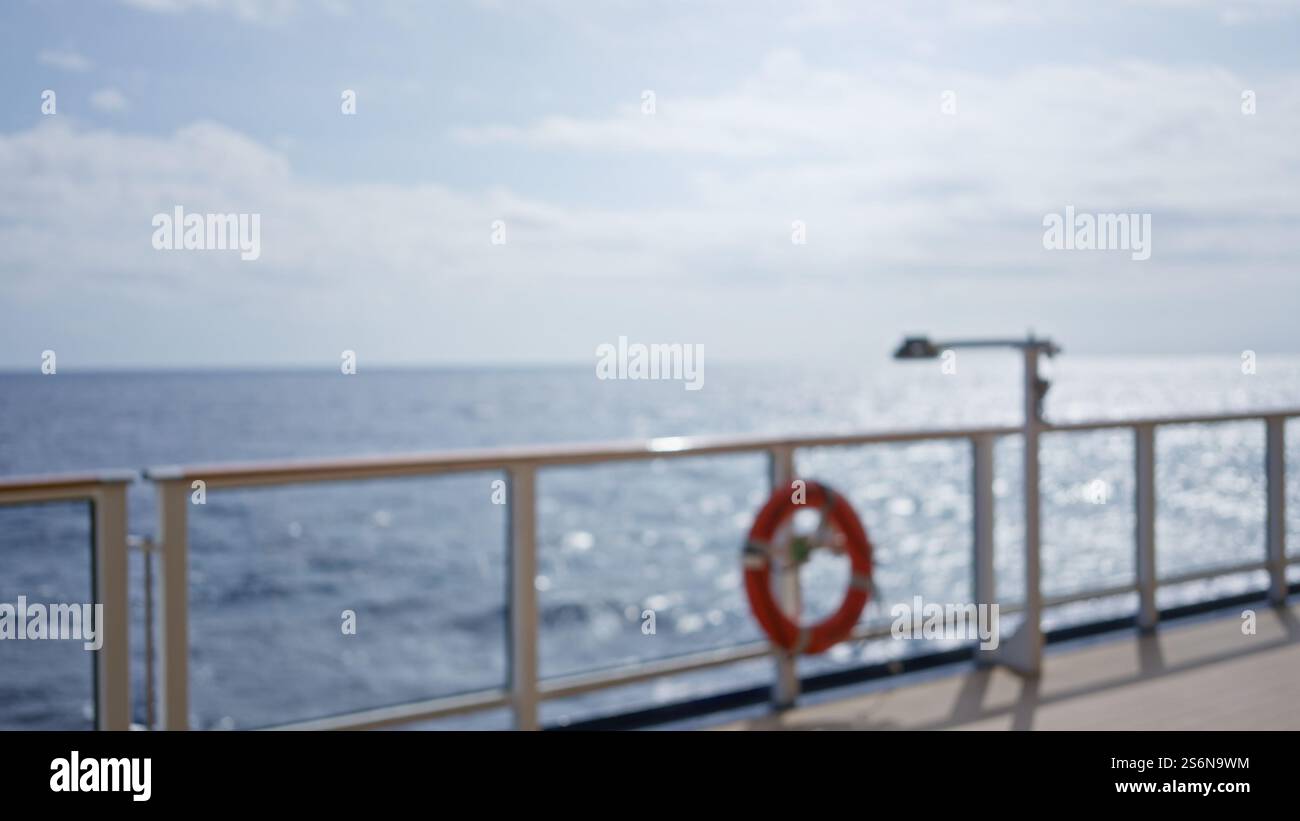 Blurred view of a luxurious outdoor cruise setting with defocused railing and ocean bokeh Stock Photo