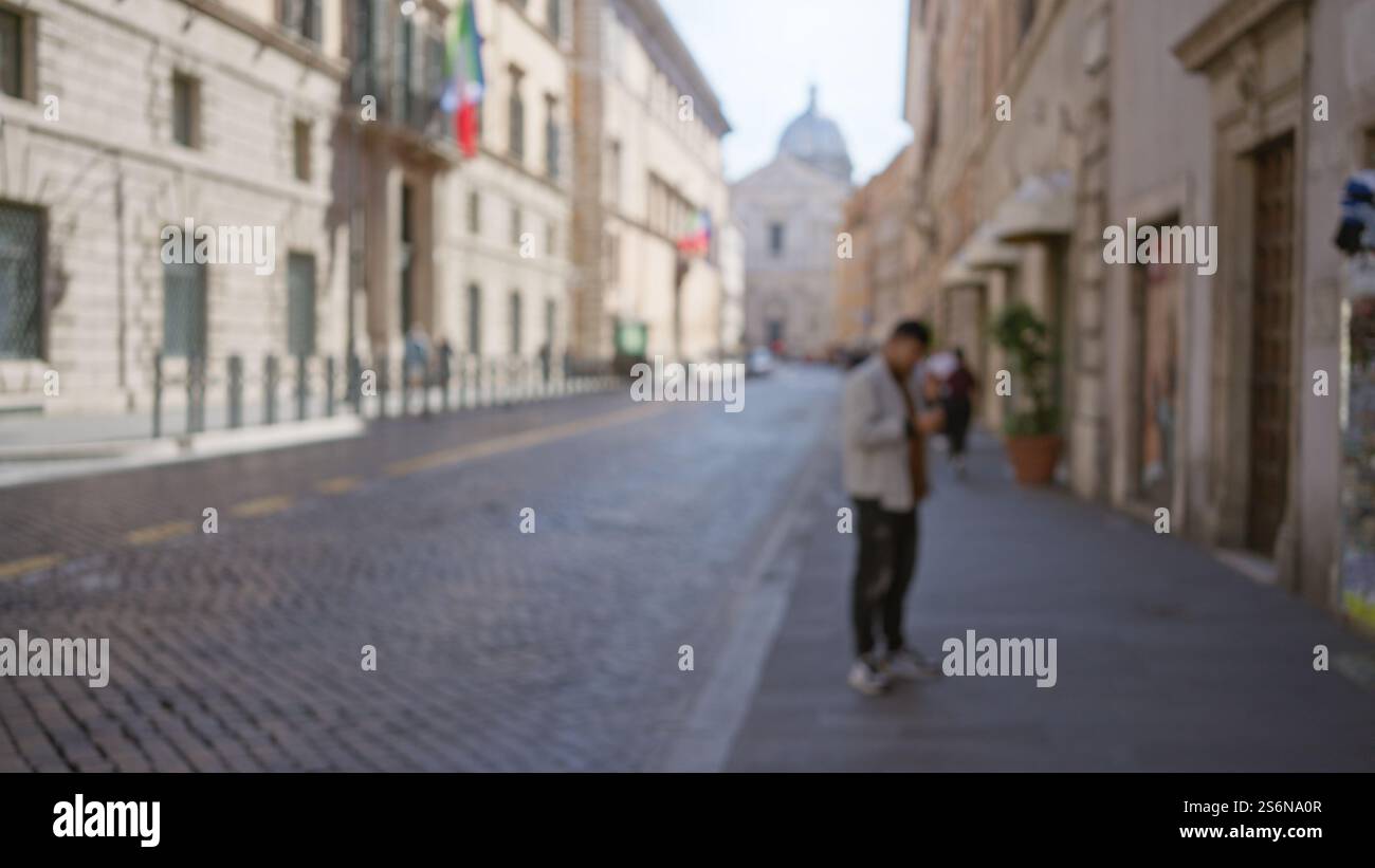 Man standing on a cobblestone street in rome, italy with blurred ...