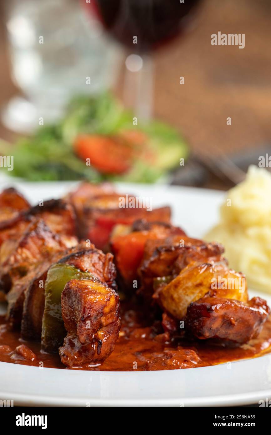 Grilled meat on a skewer with mashed potatoes Stock Photo