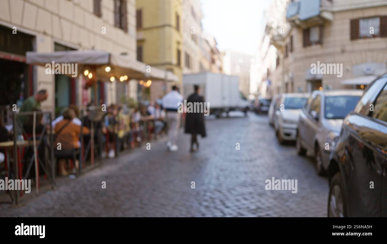 Blurred street scene in rome with people walking and outdoor cafes ...