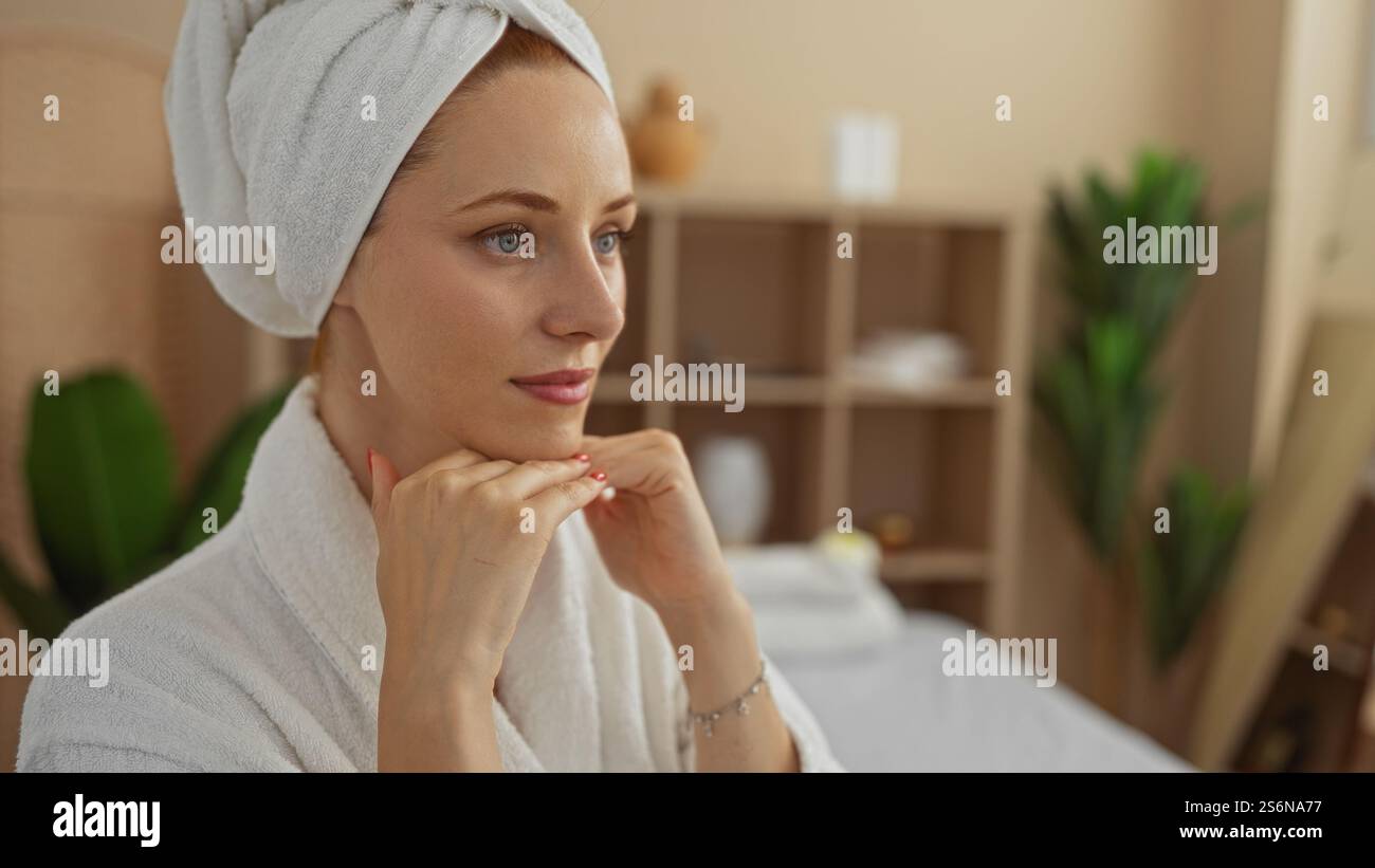 Woman relaxing in spa wearing towel on head and robe with serene ...