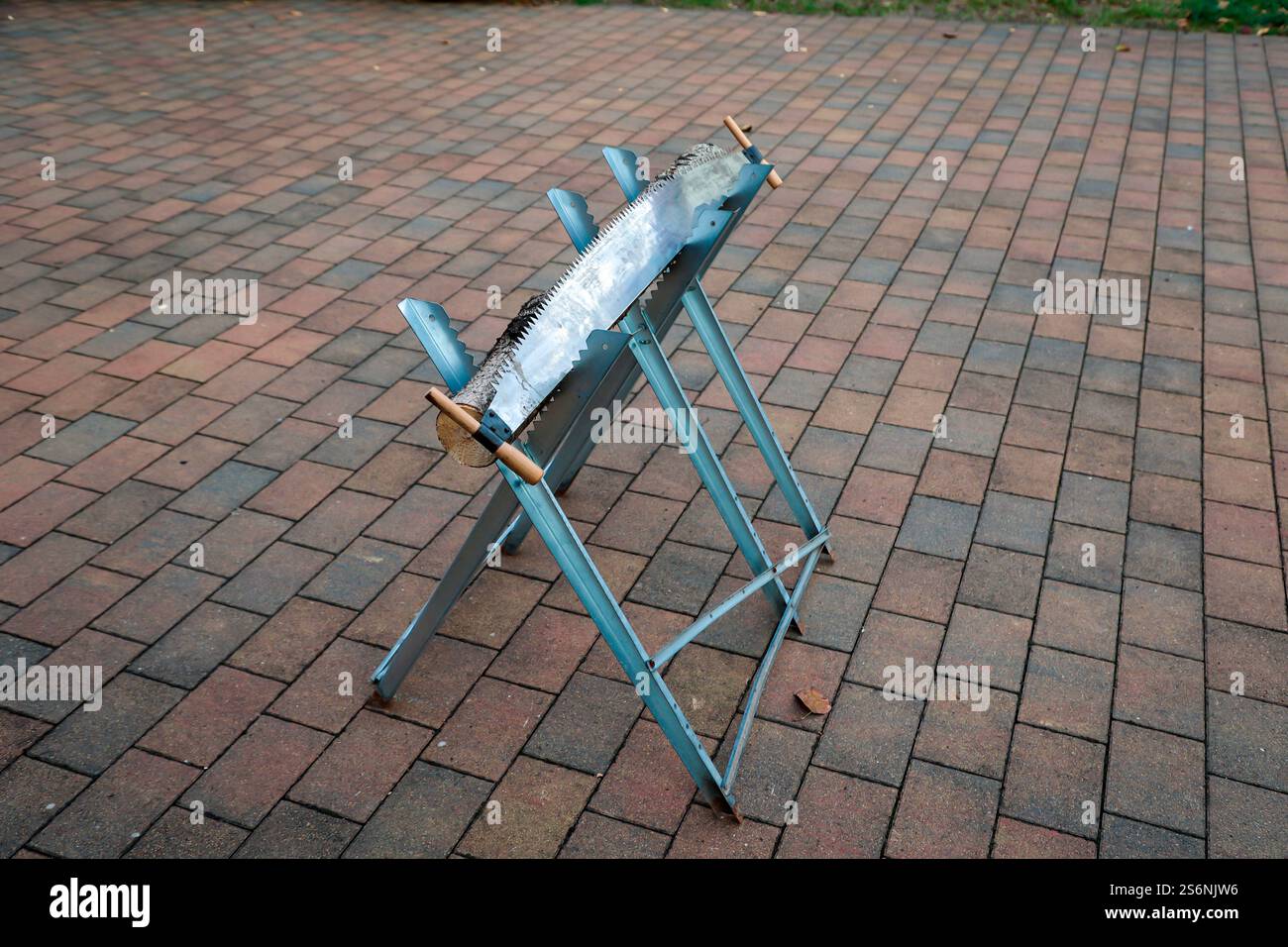 Details of a sawbuck with tree trunk and saw at a wedding Stock Photo
