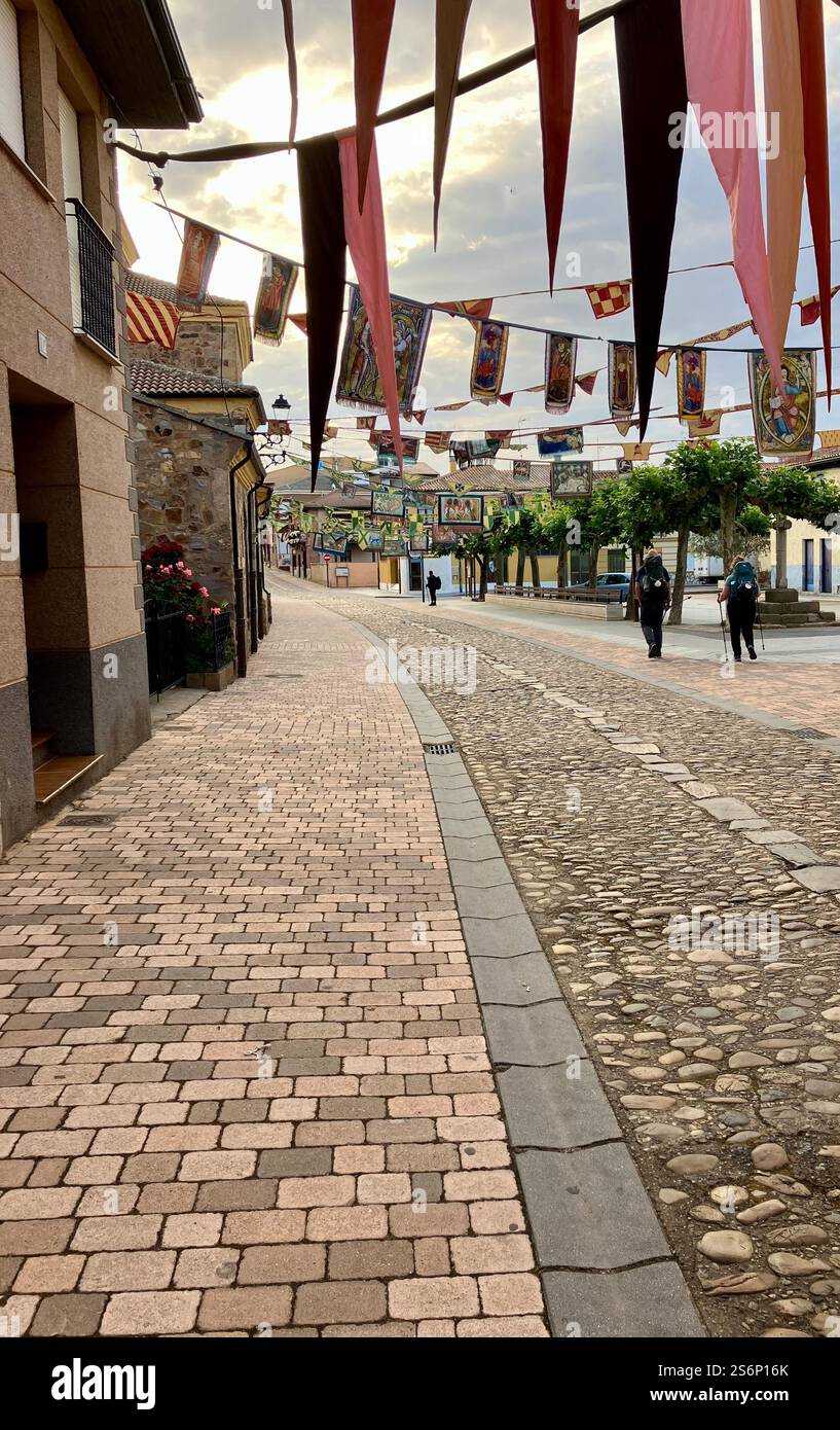 Hospital de Órbigo; Flags, Bunting, Pilgrims Walking the Camino Frances, Camino de Santiago in Spain in Summer - Smartphone Captured Stock Image