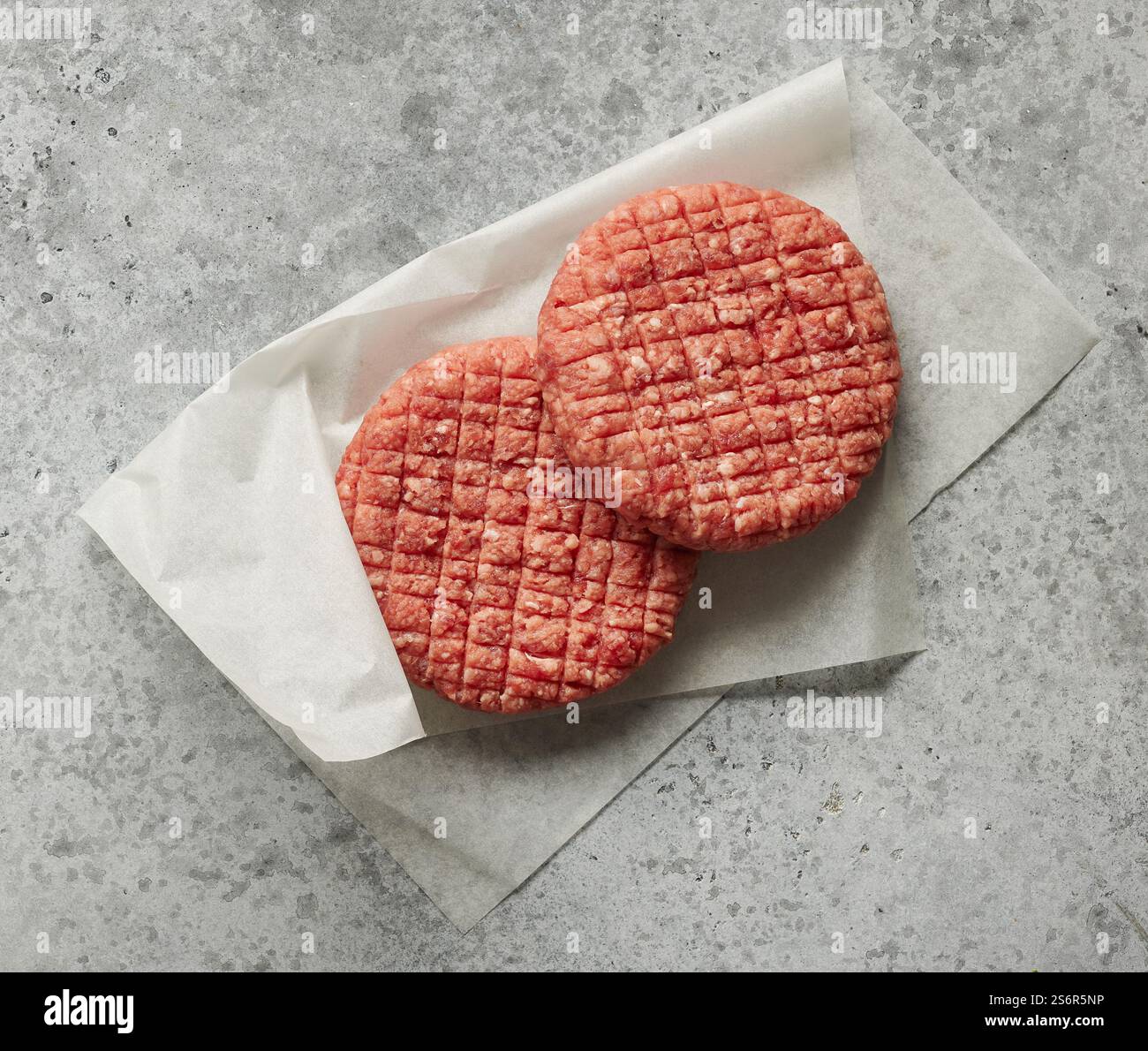 fresh raw burger meat on grey kitchen table, top view Stock Photo