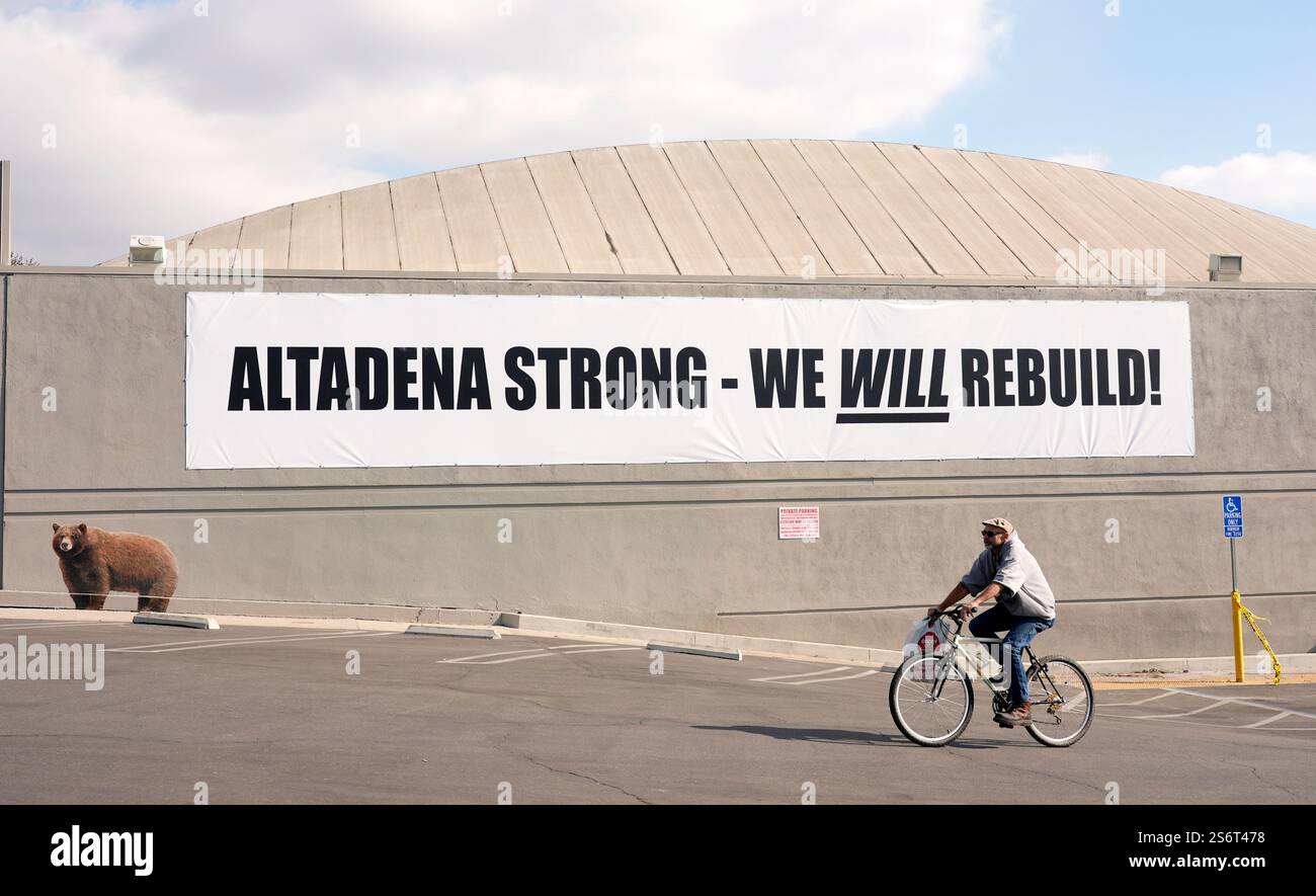 Dan Fernandez, a 30-year resident of Altadena, Calif, cycles past an ...