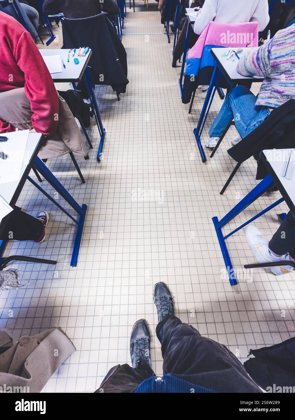 Examination in a high school, supervisor passing in the corridors Stock Photo