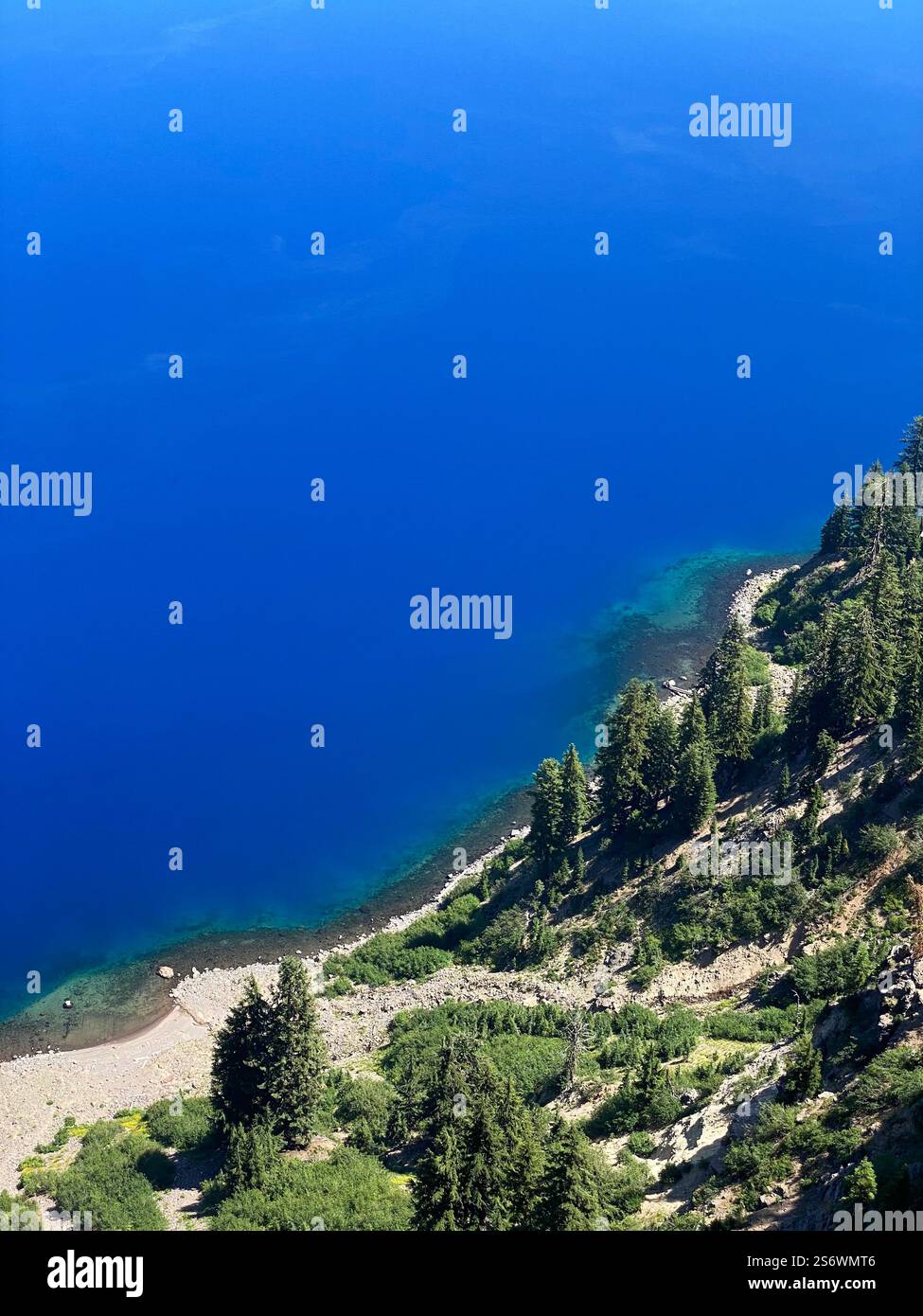 Deep blue water of Crater lake at Crater Lake National Park in Oregon on a sunny summer day. - Smartphone Captured Stock Image