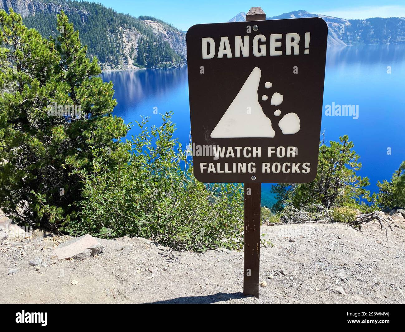 A danger sign warning of falling rocks, on a hiking trail at Crater Lake National Park in Oregon. - Smartphone Captured Stock Image