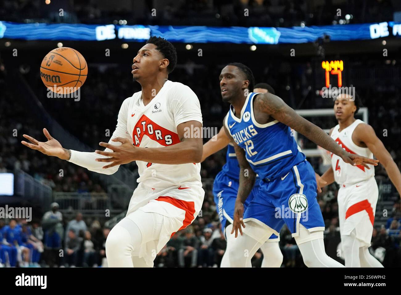 Toronto Raptors' RJ Barrett, left, loses control of the ball in front ...