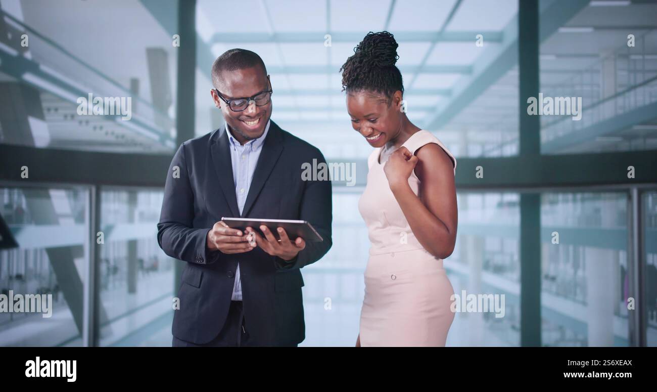 Businesspeople Discussing Standing Inside Elevator At Work Stock Photo